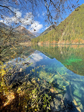 The breathtaking scenery of the crystal-clear turquoise lake with autumn colors at Jiuzhaigou National Park in Sichuan Province, China