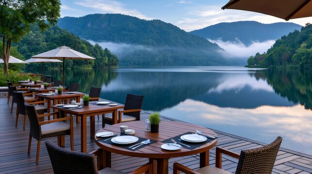 Outdoor restaurant dining on peaceful lake with mountains