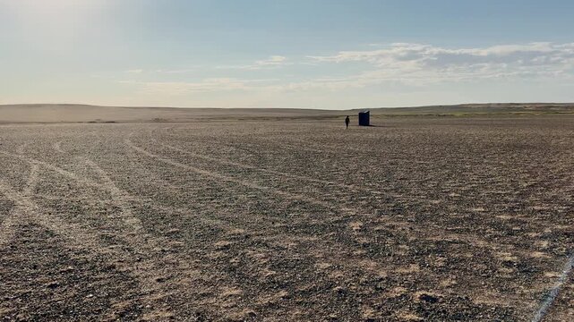 Rear view of the woman going to toilet in Gobi desert