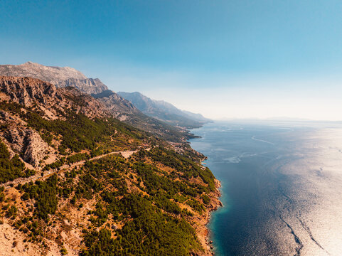 Aerial panoramic view of Makarska Riviera with turquoise Adriatic sea and Biokovo mountain range in the background, Dalmatia, Croatia.