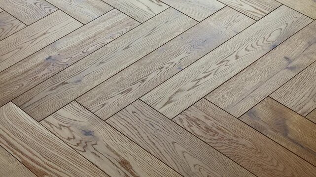 Vintage oak parquet flooring herringbone texture as background. Wooden floor pattern for real estate presentation, design and maintenance.