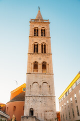 Fototapeta premium Zadar, Croatia. Old town street of Zadar with the Church of St. Donatus and the bell tower of the Cathedral of St. Anastasia at sunset.