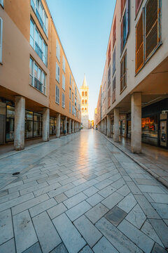 Zadar, Croatia. Old town street of Zadar with the Church of St. Donatus and the bell tower of the Cathedral of St. Anastasia at sunset.