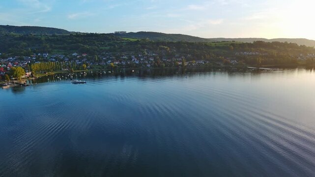 Scenic Aerial View of Lake Village Shoreline During Golden Hour Sunset