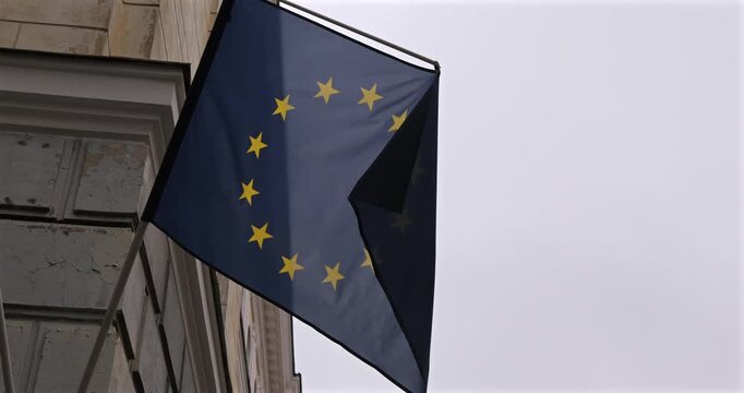 close-up European Union flag hanging on a building 