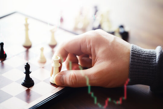 Black and White chess with player, Businessman and Businesswoman shaking hands after end game of thinking strategy to moving chess figure in competition with opposite player and planning.