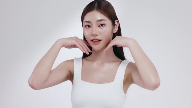 Slow motion of beautiful young Asian girl with k-beauty make up style on isolated white background for commercial beauty advertising.