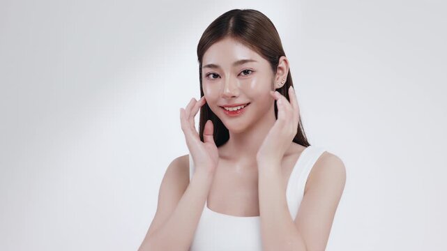 Slow motion of beautiful young Asian girl with k-beauty make up style on isolated white background for commercial beauty advertising.
