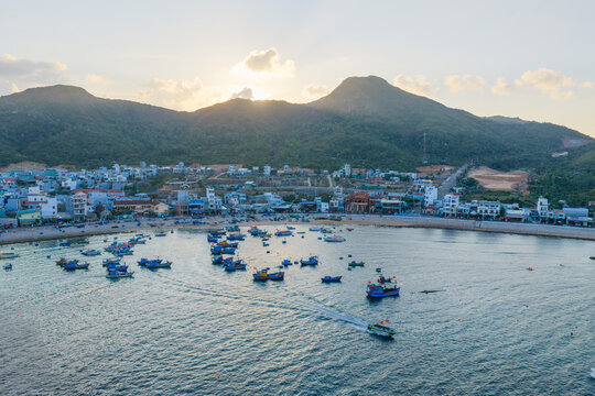 Aerial view of fishing boats and turquoise sea during golden seaweed season in Nhon Hai, Binh Dinh