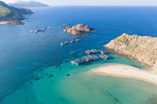 Panoramic aerial view of Nhon Hai fishing village, beach, and sparkling sea in Binh Dinh province, Vietnam