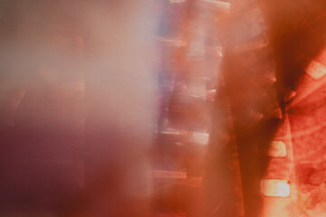 Artistic closeup of overexposed analogue camera film stripes with rainbow light leaks, radiant lens flare, translucent abstract color distortions and vintage photographic texture. © juliasudnitskaya