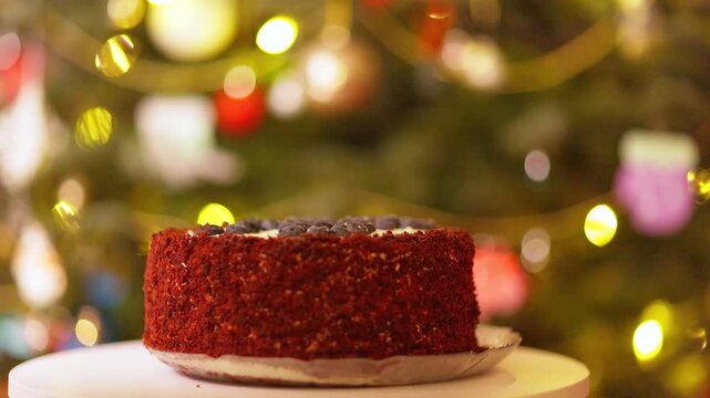 Festive Red Velvet Cake with Blueberries Against Bokeh Christmas Lights
