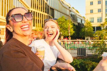 Fototapeta premium Happy women sharing laughter and conversation outdoors during sunset
