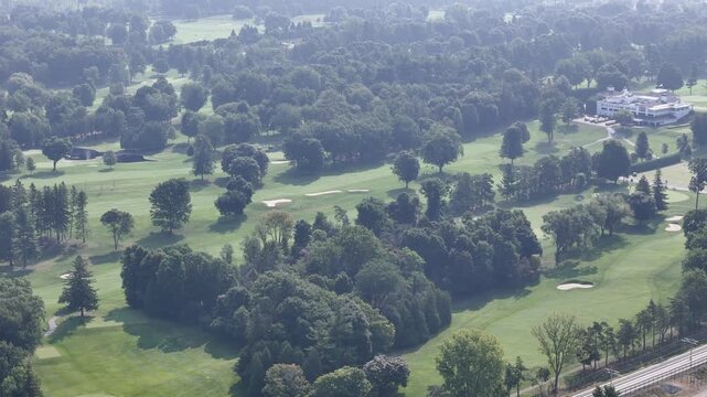 Aerial view of lush golf course near Laval Quebec Canada with ponds, trees and fairways. g.