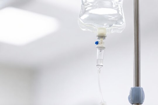IV drip bag hanging from a pole in a hospital setting
