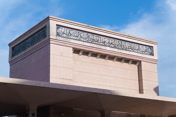 Low angle view of classic building roofline and decorative ornate facade against blue sky. © Afiq