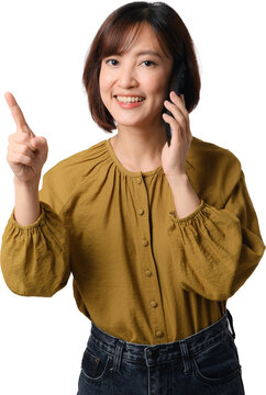 Happy asian woman talking on mobile phone and pointing finger up with joyful smile standing isolated on transparency background