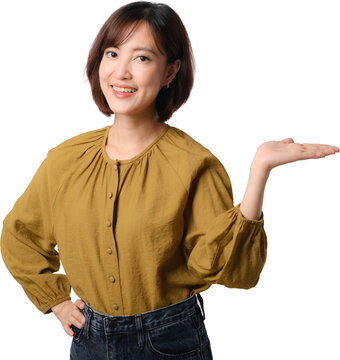 Happy smiling asian woman presenting copy space with open palm gesture standing isolated over transparency background cutout