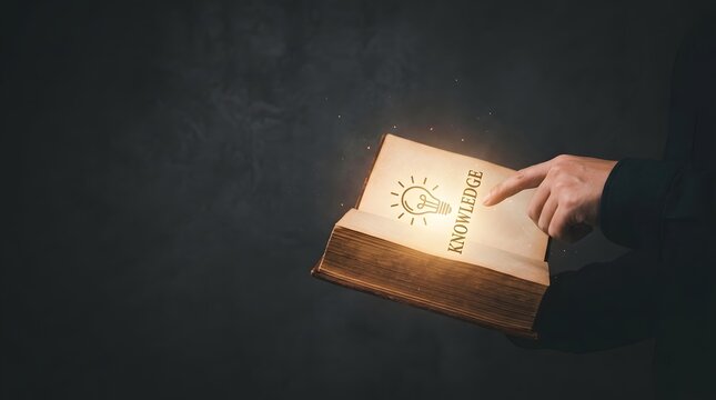 Person pointing at a glowing lightbulb symbol on an open book