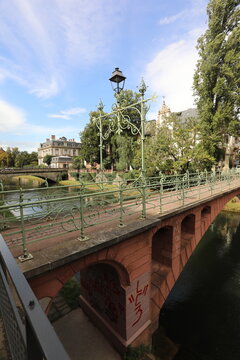 Ornate bridge with lamppost over a canal in Strasbourg, France