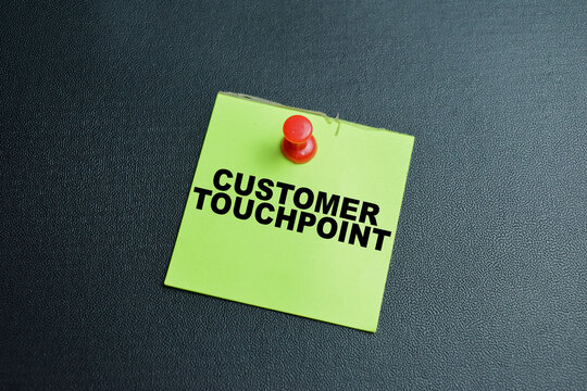 Concept of customer touchpoint write on sticky notes isolated on table.