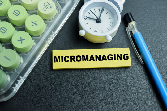 Concept of micromanaging write on sticky notes isolated on table.