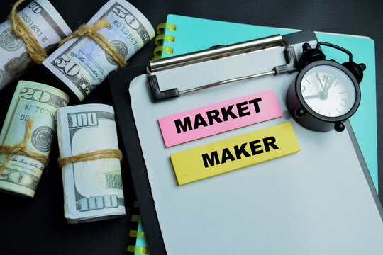 Concept of market maker write on sticky notes isolated on table.