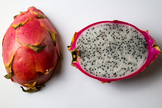 Whole and Cut Dragon Fruit on White Background