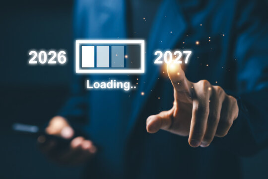 Business professional touches 2027 beside loading progress interface, representing new year transition, future planning, digital transformation, business goals, change, and progress.