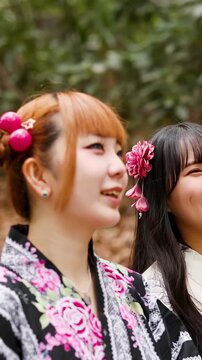 Two Japanese Women in Traditional Yukata Smiling Outdoors in Tokyo