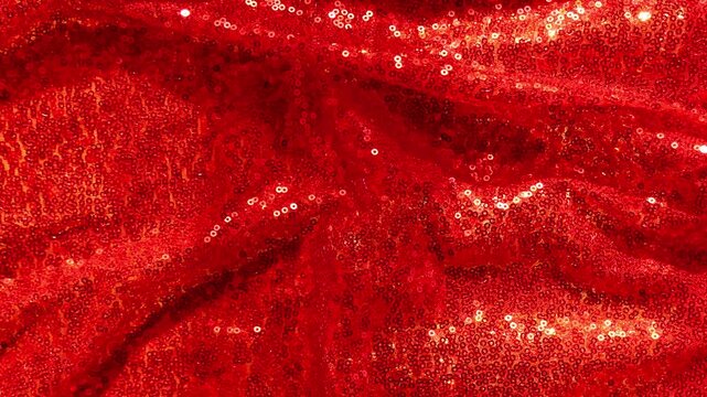 Sparkling Red Sequin Fabric Waves as Holiday Background.red shimmer celebration background. 4k footage