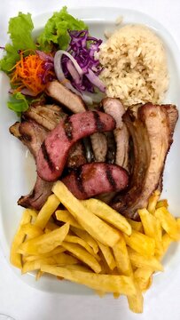 Grilled pork ribs with chorizo, potatoes and salad