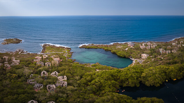 Panorama of beach with a stunning cliff overlooking the Caribbean Sea, luxury resort and palm trees surrounded.Summer concept, Playa del Carmen, Riviera Maya, Mexico.