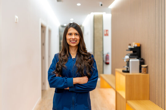 Professional woman standing in modern aesthetic clinic hallway