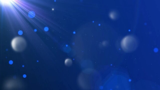 Abstract blue background with glowing light particles and soft lens flare bokeh effect.