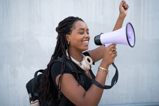 A young African American woman enthusiastically speaking