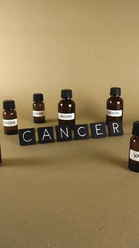 Conceptual representation of the ongoing search for a cancer vaccine with vials and lettering on a brown background. Scientific and medical progress fighting the deadly disease