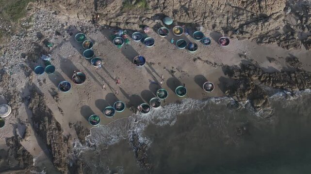 Aerial drone view of Mui Ne fishing village and Ganh Da Mui Ne coastline in Lam Dong, Vietnam, with fishing boats at sea, sandy beaches and a scenic coastal landscape.