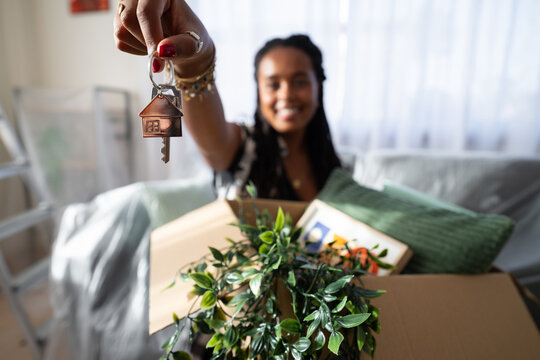 A African American woman holds a house key