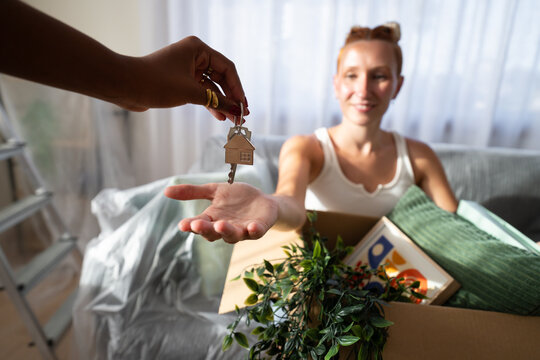 A white woman receives house keys while moving into a new home