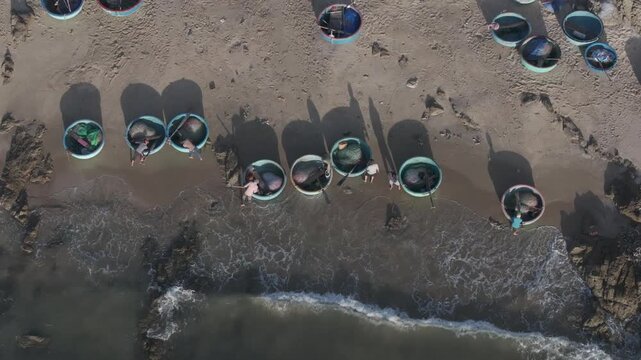 Aerial drone view of Mui Ne fishing village and Ganh Da Mui Ne coastline in Lam Dong, Vietnam, with fishing boats at sea, sandy beaches and a scenic coastal landscape.