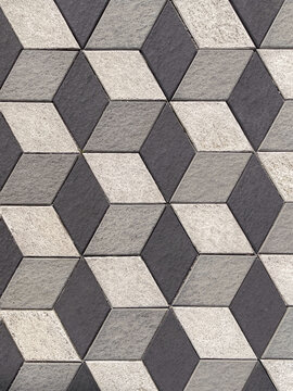 Abstract geometric cube pattern in monochrome gray tones, creating a modern three-dimensional optical illusion and decorative architectural background.