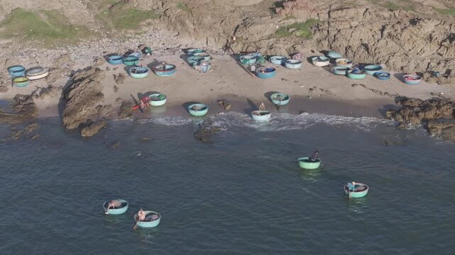 Aerial drone view of Mui Ne fishing village and Ganh Da Mui Ne coastline in Lam Dong, Vietnam, with fishing boats at sea, sandy beaches and a scenic coastal landscape.