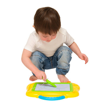 Little boy drawing with magnetic stylus on writing board. Child playing with educational creative toy. Early learning development for toddler. Isolated on transparent background studio shot.