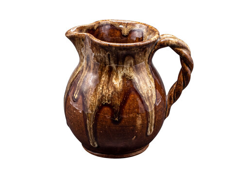 Rustic brown ceramic pitcher with a unique twisted handle and drippy glaze.