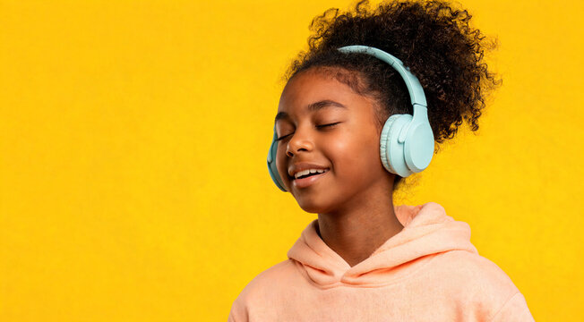 Girl listens to music with headphones in a bright setting