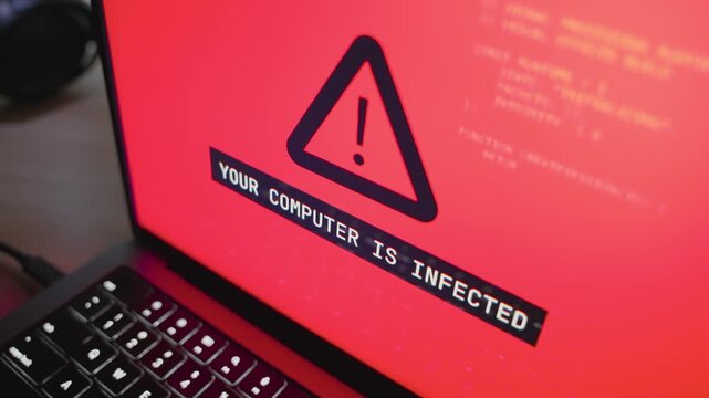 Digital warning message alerts on potential cyber threat affecting laptop computer. Stealing and accessing personal private data and information by hacker group or spy cyber crime agency. Red screen