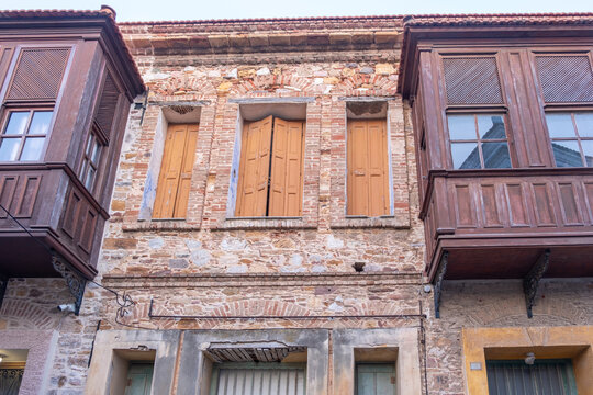 Traditional timber bay windows crown a weathered facade in Chios Town on Chios Island, Greece