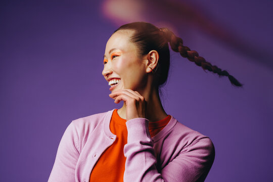 Asian woman beauty portrait with smiling expression in studio profile
