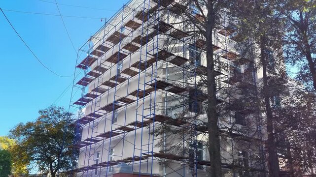 Building facade renovation with construction scaffolding